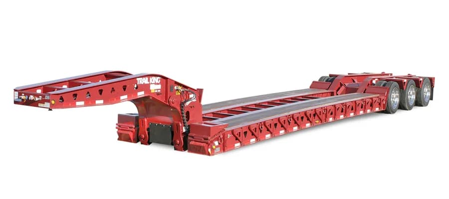 Trail King TKHDG Hydraulic Detachable Gooseneck trailer with low-profile deck, hydraulic cylinders, and V-shaped alignment guide for heavy equipment loading.